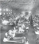  ?? AP ?? Influenza victims crowd into a hospital in Kansas in 1918. The virus wiped out as many as 50 million.