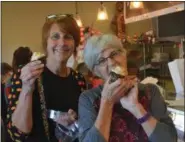  ?? KEITH REYNOLDS — THE MORNING JOURNAL ?? Beth Schaefer (left), 49, of Lorain, and Mary Jankowski, 69, of Vermilion, briefly pose before digging into anise cupcakes at Kiedrowski’s Simply Delicious Bakery, 2267 Cooper Foster Park Road in Amherst, on Oct. 1 as part of the opening day of the...
