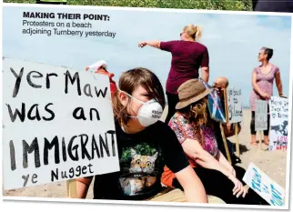  ??  ?? MAKING THEIR POINT: Protesters on a beach adjoining Turnberry yesterday