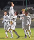  ?? GREG SORBER/JOURNAL ?? La Cueva’s Andres Zanios lifts teammate Marco Monetti after Monetti scored in the first half of the Bears’ 3-2 win over Eldorado at the APS Soccer Complex.