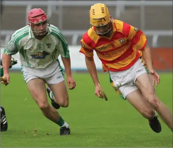  ??  ?? Buffers Alley’s Senior newcomer, John Lee Meyler, races away from Barry Carton (Cloughbawn).