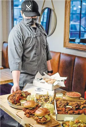  ?? SPECIAL TO TORSTAR ?? Matty Cipollo with a sampling of menu items from his pop-up, Matty’s Hot Chicken, which will operate in St. Catharines at Lost+Found Taqueria and in Hamilton at UnDefined.