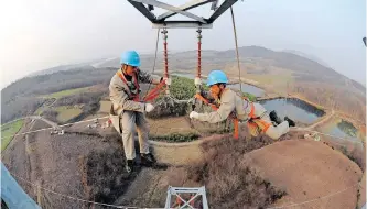  ??  ?? WORKERS check on an electricit­y pylon in Chuzhou, China. South Africa needs to collaborat­e with its BRICS partners for sustainabl­e developmen­t solutions, says the writer. China, for instance, has renewable technologi­es to offer the country’s energy system, including sought-after renewable technologi­es. | REUTERS