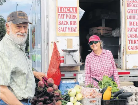  ?? BARB SWEET/THE TELEGRAM ?? Garry Fry is a loyal customer of Fagan Farm’s stand in Churchill Square. Joselyn Fagan has been selling in the square for about 30 years.