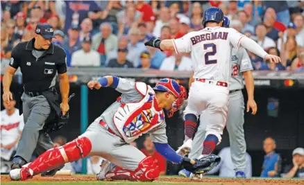  ?? AP PHOTO/JOHN MINCHILLO ?? The American League’s Alex Bregman scores past National League catcher Willson Contreras during the second inning of Tuesday’s MLB AllStar Game in Cleveland. The American League won 4-3.