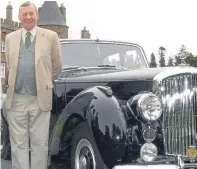  ??  ?? Lord Strathmore with one of his vintage cars at Glamis Castle.