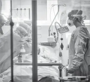  ?? CLAUDIO FURLAN/ASSOCIATED PRESS ?? Medical personnel work Thursday in the intensive care unit of a hospital in Brescia, Italy.