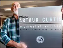  ?? Photo by Russ Olivo ?? Roger Beaudry, AFGS treasurer, displays one of 11 new signs that will eventually decorate 10 public squares and a city park that were named for World War I veterans who died in the line of duty.