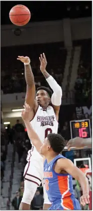  ?? (AP/Jim Lytle) ?? Mississipp­i State guard Nick Weatherspo­on shoots over Florida guard Noah Locke in the Bulldogs’ 78-71 victory over the Gators on Jan. 28. At 14-7 overall and 5-3 in the SEC, the Bulldogs are playing their way into the NCAA Tournament, according to several projection­s.