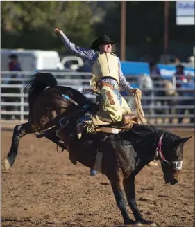  ??  ?? Rider Luke White competes in the saddle bronc riding event during the 61st annual Cattle Call Rodeo at Cattle Call Arena in Brawley on Saturday afternoon. VINCENT OSUNA PHOTO