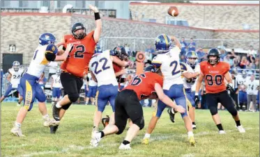  ?? PILOT PHOTO/RON HARAMIA ?? Triton QB Cole Shively (2) gets this pass off while under duress from Culver’s Auston Zehner (72), Hunter Evans (76) and Marquez Anderson (80). Shively had three touchdown passes in the Trojan win.