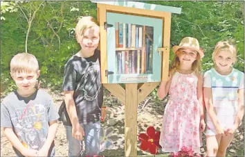  ?? Lisa Reisman / For Hearst Connecticu­t Media ?? Emory Bova, Nolan Zawecki, Ava Rose Juliano, and Cece Bova at the grand opening of Little Free Library No. 71558 on Green Hill Road in Madison.