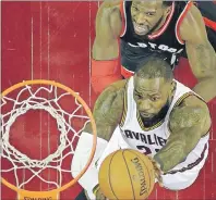  ?? AP PHOTO ?? Cleveland Cavaliers forward LeBron James drives to the basket against Toronto Raptors forward DeMarre Carroll in the first half of Monday’s Game 1 of the second-round playoff series.