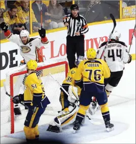  ?? AP PHOTO ?? Anaheim Ducks’ Ryan Getzlaf (15) and Nate Thompson (44) celebrate after the winning goal got past Nashville Predators goalie Pekka Rinne during overtime in Game 4 of the Western Conference final Thursday. It was the 47th one-goal game of this year’s...