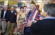  ?? ERIK TRAUTMANN — HEARST CONNECTICU­T MEDIA VIA AP ?? Veteran Peter Torreno receives a quilt made for him during a Quilts of Valor presentati­on, as Norwalk Mayor Harry Rilling, State Senate Majority Leader Bob Duff and Christie Ruiz look on at Christie’s Quilting Boutique in Norwalk.