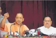  ?? HT PHOTO ?? Union health minister JP Nadda (R) looks on as UP CM Yogi Adityanath gestures as they address a press conference after visiting the BRD Medical College in Gorakhpur on Sunday.