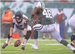  ?? ADAM HUNGER, USA TODAY SPORTS ?? The Falcons’ Matt Ryan recovers a fumble in front of the Jets’ Jordan Jenkins on Sunday.