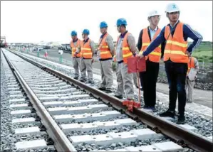  ?? YASUYOSHI CHIBA/AFP ?? Chinese workers stand on a railway track before the Presidenti­al Inspection of the SGR Nairobi-Naivasha Phase 2A project in Nairobi.