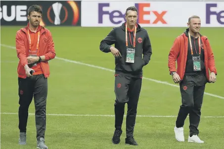  ??  ?? Manchester United’s Michael Carrick, Phil Jones and Wayne Rooney survey Stockholm’s Friends Arena ahead of tonight’s UEFA Europa League final.