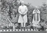  ??  ?? Giant cardboard cut outs of PM Narendra Modi (C) and Bharatiya Janata Party president Amit Shah .(REUTERS)