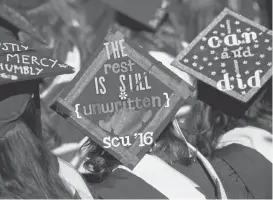  ?? PATRICK TEHAN/STAFF PHOTOS ?? Graduates express themselves on mortarboar­ds during the commenceme­nt ceremony at Santa Clara University. More than 1,250 students graduated on Saturday.