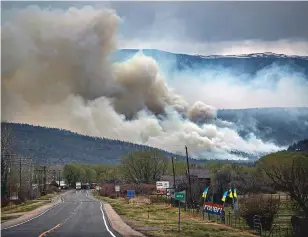  ?? JIM WEBER/NEW MEXICAN FILE PHOTO ?? The Hermits Peak/Calf Canyon Fire burns in 2022 near Cleveland, N.M., as smoke darkens the sky over Mora. Two more lawsuits have been filed over compensati­on for the fire.