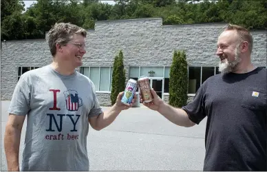  ?? MEDIANEWS GROUP ?? Artisanal Brew Works owners Colin Quinn and Kurt Borchardt toast to the company’s upcoming expansion in Wilton.