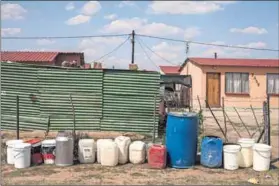  ??  ?? Parched land: Warden’s traditiona­l mainstay of farming (left) has been curtailed by the scarcity of water in the area. Despite funds being earmarked for services, residents of Ezenzeleni township still have to queue for water from a tanker every...