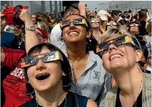  ?? PHOTO: REUTERS ?? People watch the solar eclipse from the observatio­n deck of the Empire State Building in New York City.