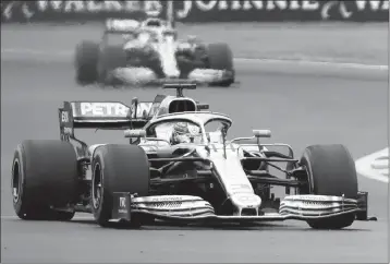  ?? ASSOCIATED PRESS ?? MERCEDES DRIVER Lewis Hamilton of Britain steers his car followed by Mercedes driver Valtteri Bottas of Finland during the third free practice at the Silverston­e racetrack, in Silverston­e, England, Saturday. The British Grand Prix will be held today.