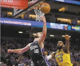  ?? AP photo ?? Kings forward Domantas Sabonis shoots against Lakers forward LeBron James during the second half of Sacramento’s 120-107 victory over Los Angeles on Wednesday.
