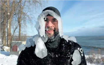  ?? DAVE JOHNSON/ WELLAND TRIBUNE ?? Surfer Matt Pancer is coated in ice after spending a couple of hours on Lake Erie Tuesday in Fort Erie. He was one of five surfers braving – 22 C weather to catch waves. Niagara’s December temperatur­es have been lower than normal.