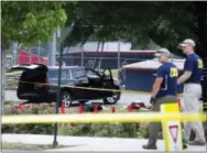  ?? ASSOCIATED PRESS FILE PHOTO ?? An SUV, with a bullet hole in the windshield and a flat tire, sits in the parking lot at the scene of a multiple shooting in Alexandria, Va., on June 14 involving House Majority Whip Steve Scalise of La., and others, during a congressio­nal baseball...