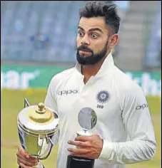  ?? PTI ?? Virat Kohli with the Man of the Match and Series trophies.