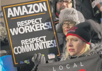  ?? DREW ANGERER/GETTY IMAGES ?? Protesters at New York City Hall on Jan. 30 rally against Amazon’s plans to put its second headquarte­rs in the Long Island City neighborho­od of Queens.