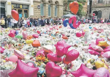  ?? — Reuters photo ?? Flowers and tributes to the victims of the attack on Manchester Arena fill St Ann’s Square in Manchester, Britain.