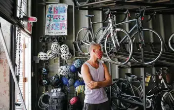  ?? Kin Man Hui / Staff file photo ?? Raymond Bohuslav waits for help with his bicycle at Blue Star Bicycling Co. in April, days after a weekslong statewide shutdown of nonessenti­al businesses was eased.
