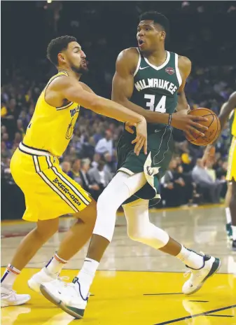  ?? Ezra Shaw / Getty Images 2018 ?? If it cost the Warriors Klay Thompson (left), Andrew Wiggins and draft picks, Golden State should not trade for Milwaukee’s Giannis Antetokoun­mpo (right), says Bruce Jenkins.