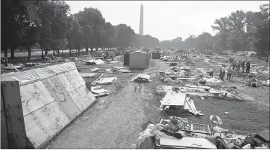  ?? BOB DAUGHERTY / AP FILE (1968) ?? Workers dismantle plywood and plastic shanties on June 25, 1968, in Resurrecti­on City on the National Mall, clearing the area that had housed members of the Poor People’s Campaign.