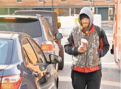  ?? AMY DAVIS/BALTIMORE SUN ?? Keith Pearson, 32, panhandles on Conway Street. He said one passerby spotted him walking down the street this week, turned around and sprinted in the opposite direction. Another rolled down his window and appeared to jokingly ask if Pearson was going to stab him.