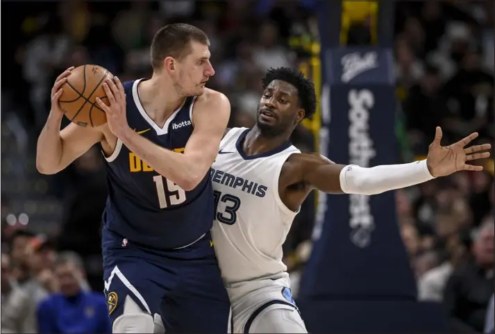  ?? PHOTOS BY AARON ONTIVEROZ — THE DENVER POST ?? Nuggets center Nikola Jokic works against Jaren Jackson Jr. of the Memphis Grizzlies during the second quarter at Ball Arena in Denver on Thursday.