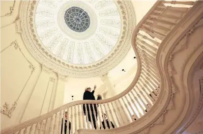  ?? ALGERINA PERNA/BALTIMORE SUN ?? Julia Marciari-Alexander, director of the Walters Art Museum, stands at the top of the Hackerman House’s grand staircase. MarciariAl­exander says the renovation project will treat the historic mansion at One West Mount Vernon Place as a work of art in...