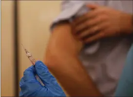  ?? LUCA BRUNO — THE ASSOCIATED PRESS ?? A nurse prepares to inject flu vaccine in Milan, Italy on Nov. 4.