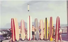  ?? Picture: © Michael Wright ?? A group of surfers at Muizenberg in the 1960s, showing off their distinctiv­ely shaped foam and fibreglass longboards.