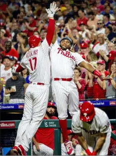  ?? LAURENCE KESTERSON — THE ASSOCIATED PRESS ?? The Phillies’ Rhys Hoskins, left, is high-fived by Maikel Franco after hitting a home run in the fourth inning.