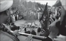 ??  ?? A U.S. flag is burned at a protest marking Internatio­nal Al-Quds Day on Friday in Islamabad, Pakistan. Al-Quds is the Arabic name for Jerusalem. The day is observed to show support for Palestinia­ns and emphasize the importance of Jerusalem to Muslims.