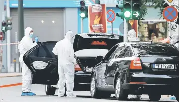  ??  ?? File photo shows Forensics officers inspect the car of Papademos following the detonation of an envelope injuring him and his driver, in Athens, Greece. — Reuters photo