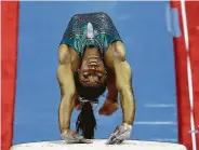  ?? Jamie Squire / Getty Images ?? Simone Biles leads the way in the vault competitio­n despite not nailing the landing Friday night.