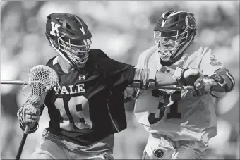  ?? TIM TAI/THE PHILADELPH­IA INQUIRER VIA AP ?? Penn State’s Kevin Fox (31) defends against Yale’s Jack Tigh (18) during Saturday’s NCAA Division I men’s lacrosse semifinal at Lincoln Financial Field in Philadelph­ia. Yale rolled to a 21-17 victory.