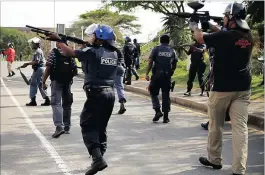  ?? PICTURES: MOTSHWARI MOFOKENG ?? Police and security chase students protesting at the UKZN Westville campus today after they burned six cars and vandalised the Risk Management building.